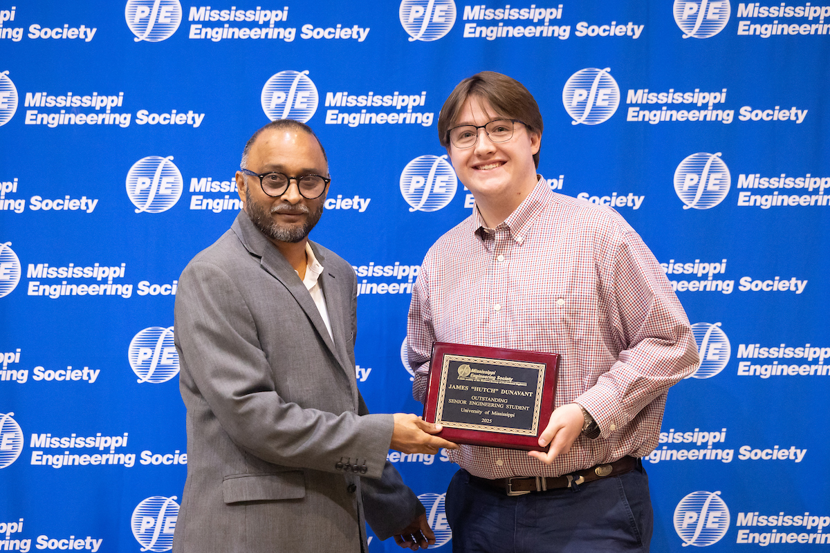 Student holding award