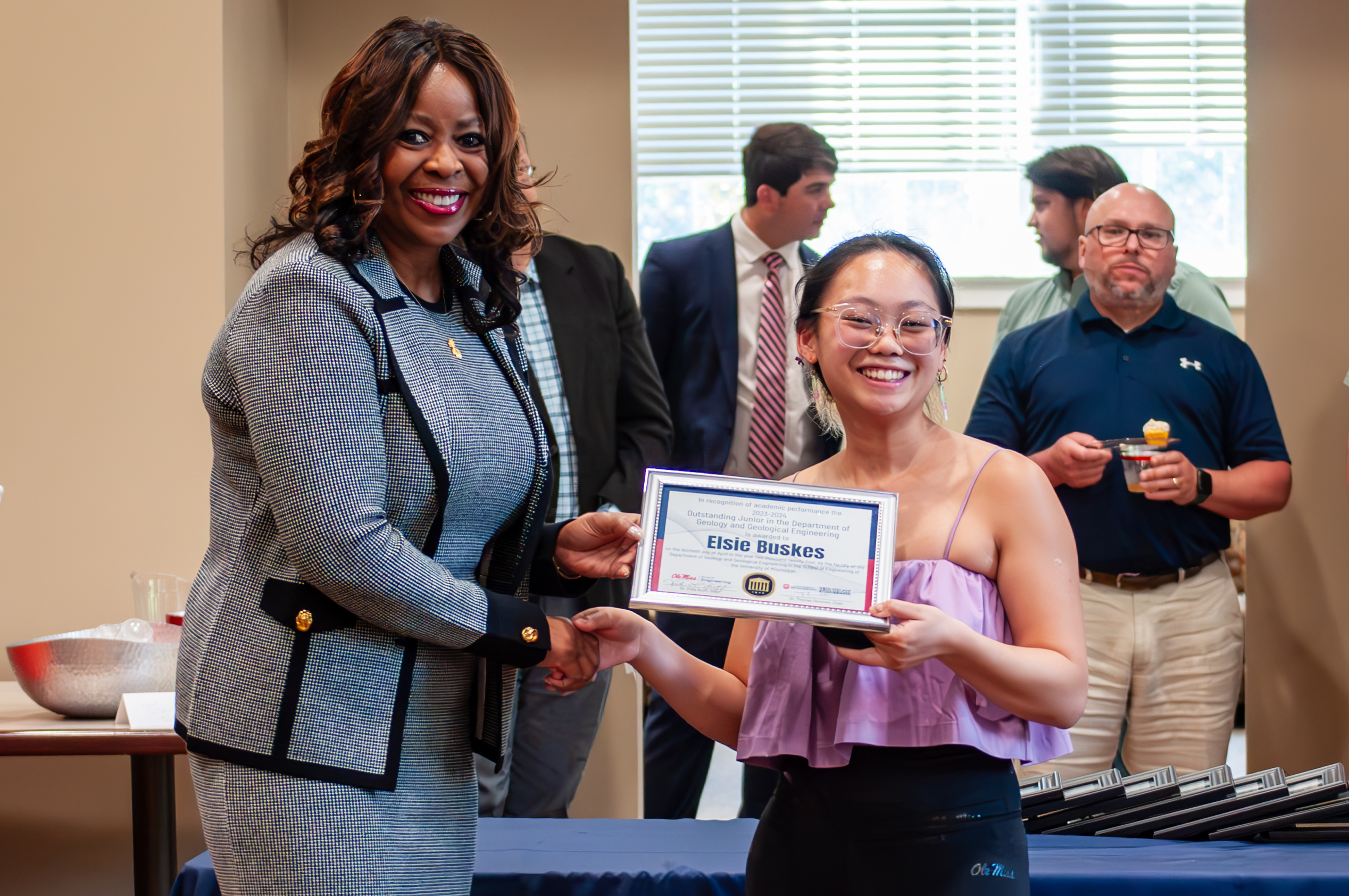 Student holding award with Dean