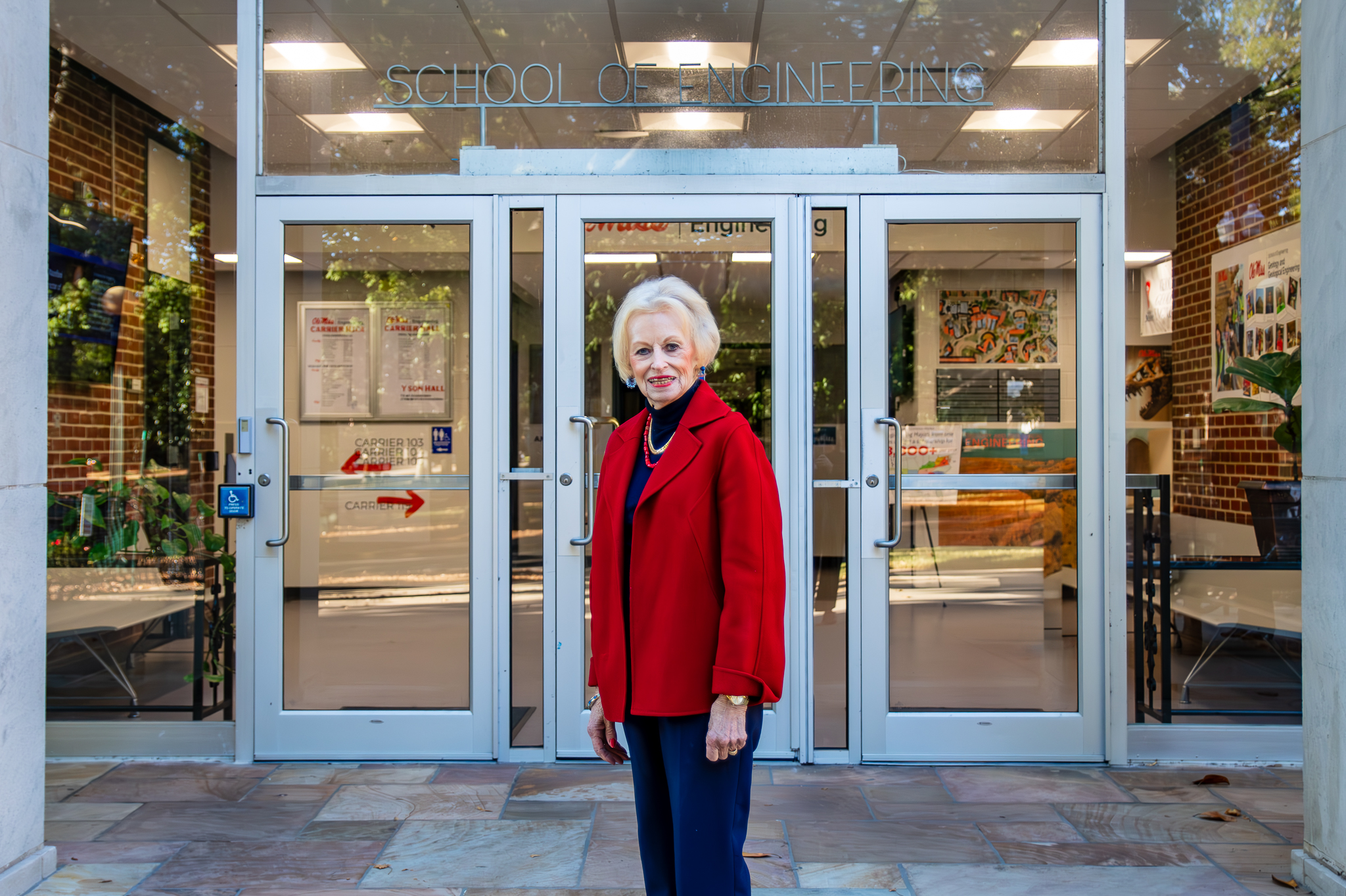 Alumni posing in front of Carrier Hall