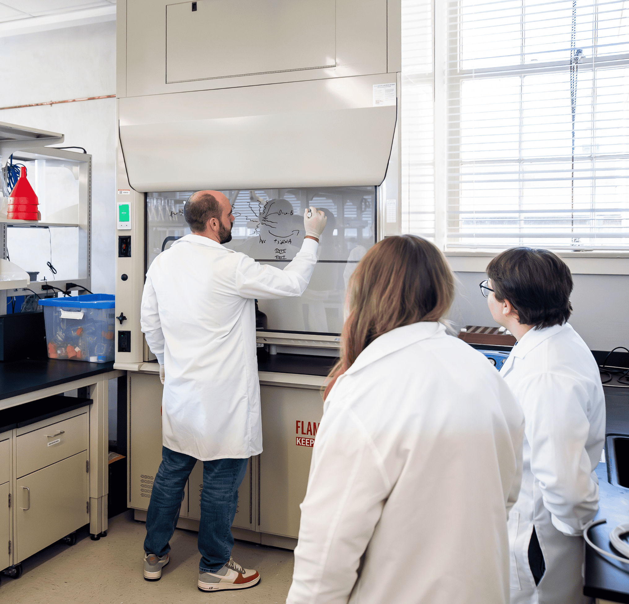 Students learning from professor in lab
