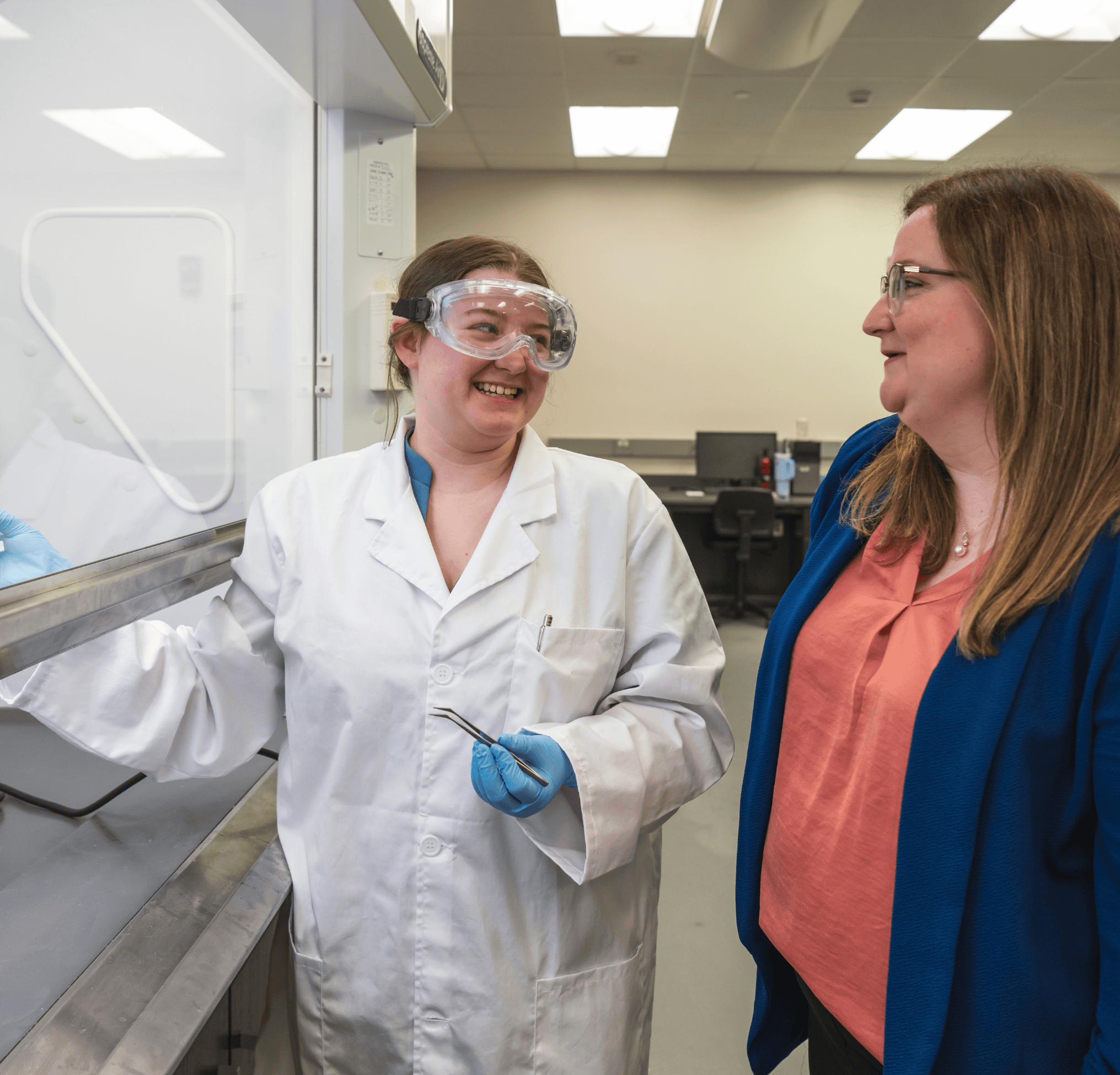 Student researcher with professor in lab