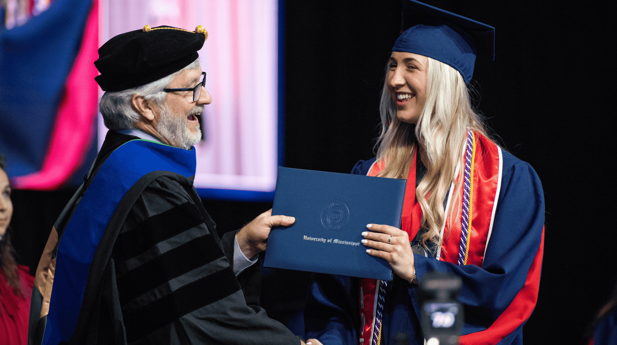 Student at graduation receiving degree