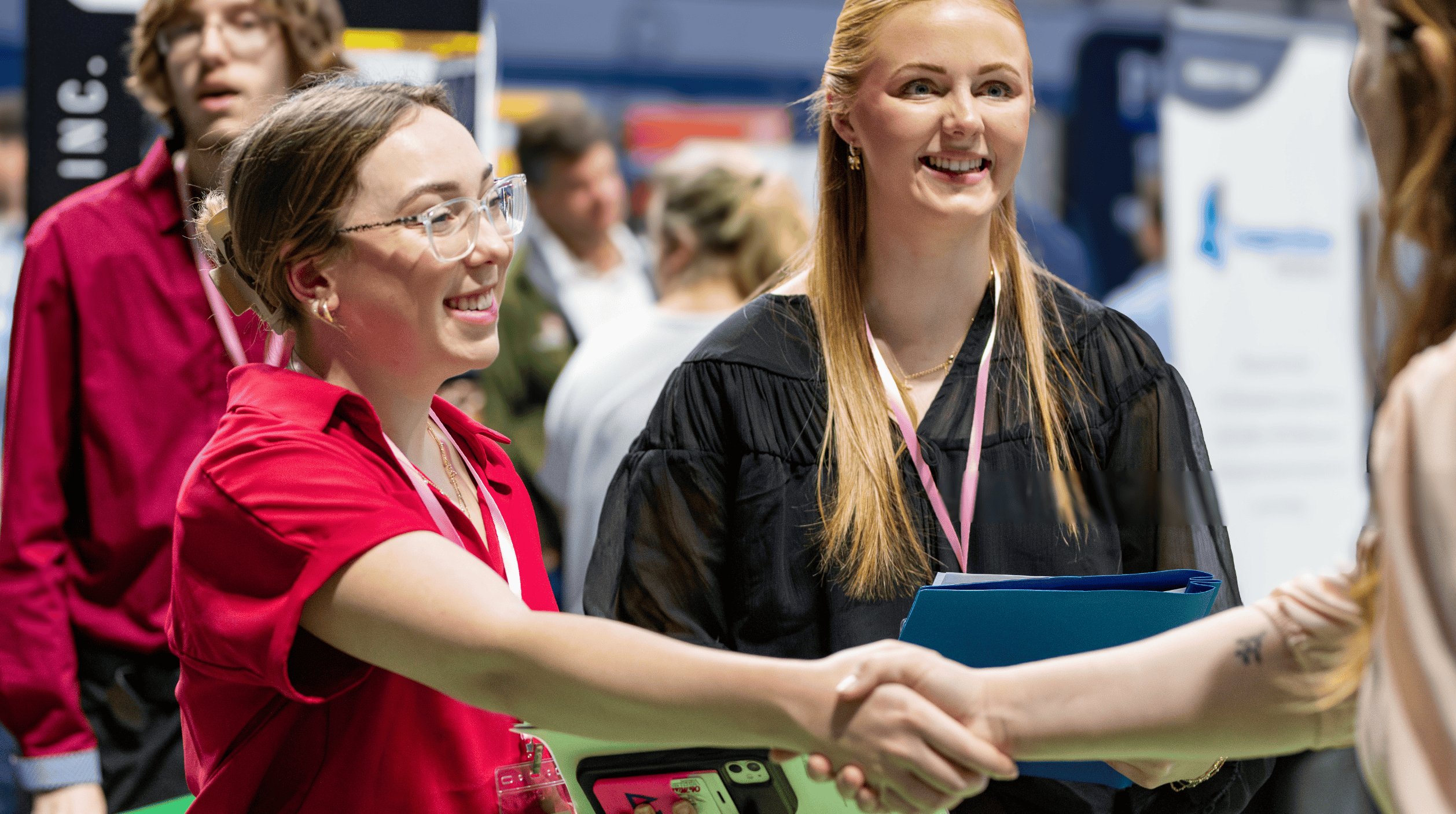 Two women shaking hands at career fair