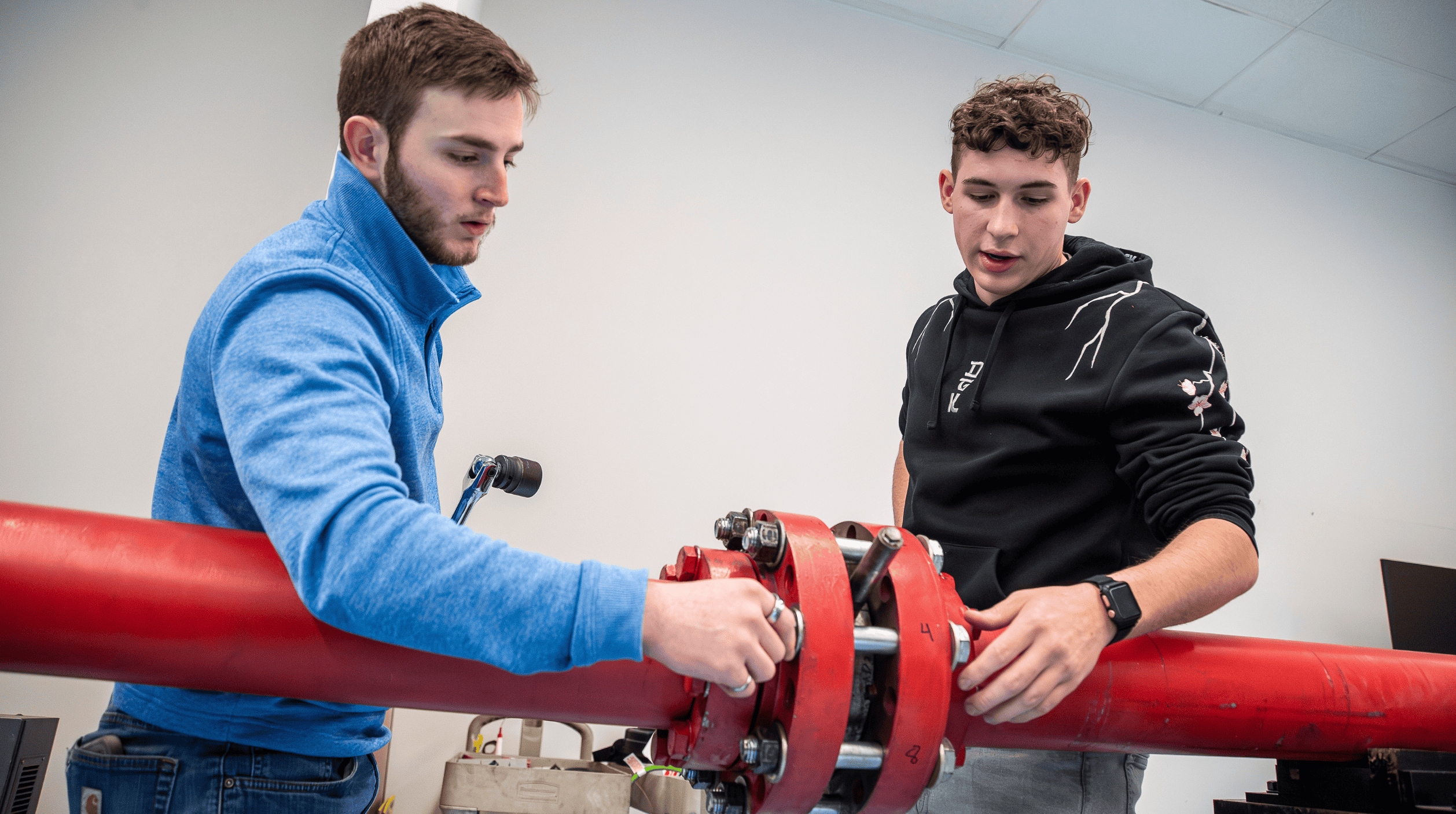 Two students working on equipment
