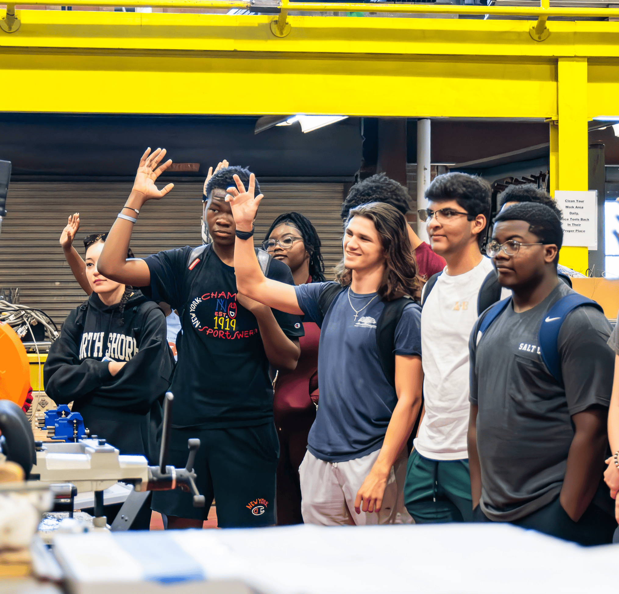 Students raising their hand during a session in lab