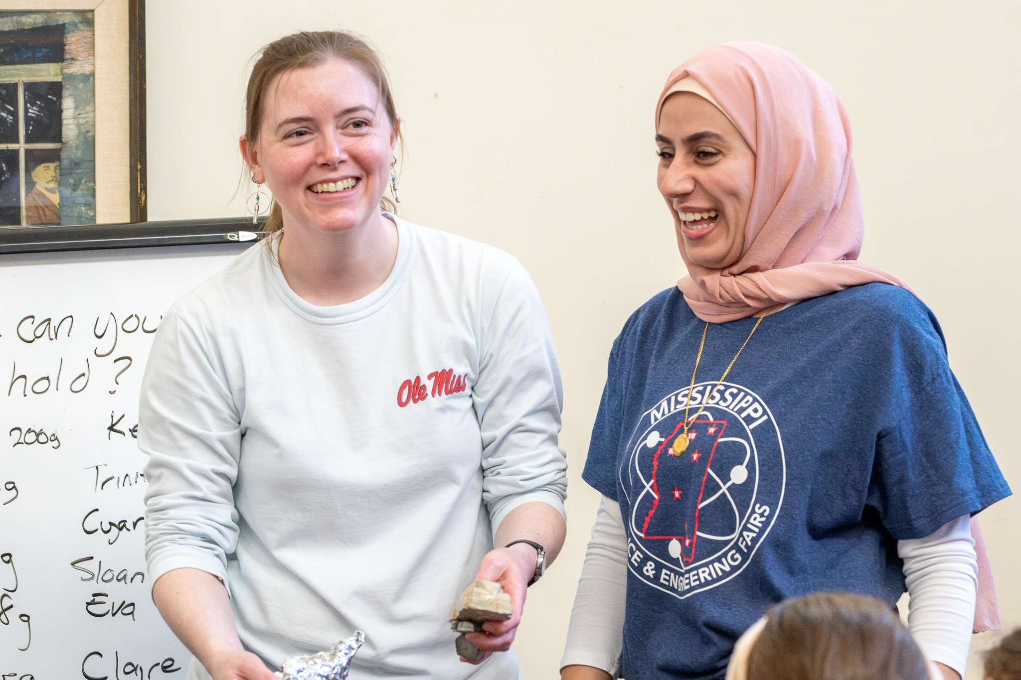 Two school of engineering staff laughing and smiling