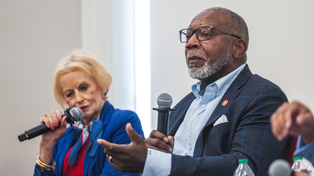 Alumnus Al Hilliard, holding a microphone, speaks to a group as part of engineering's 125th anniversary panel.