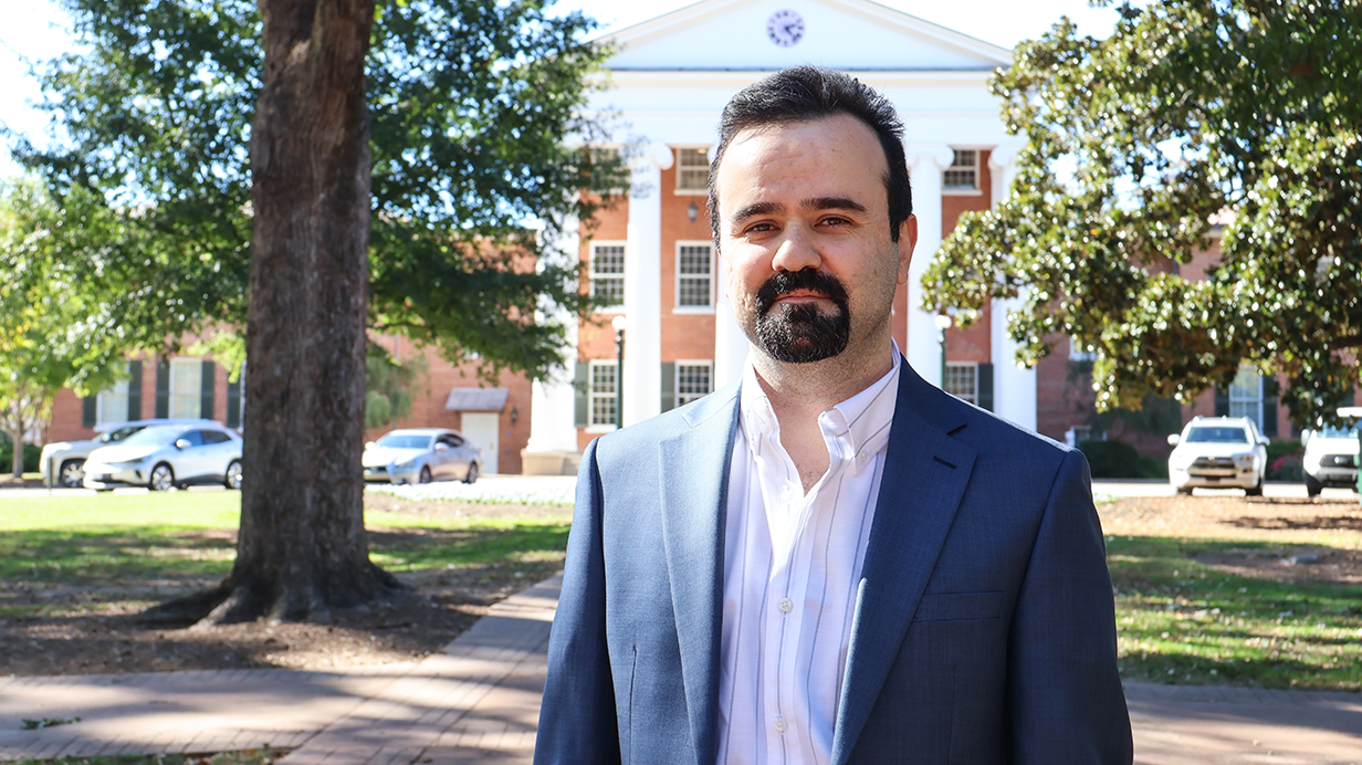 Amir Molan poses in front of the Lyceum on the Ole Miss campus.