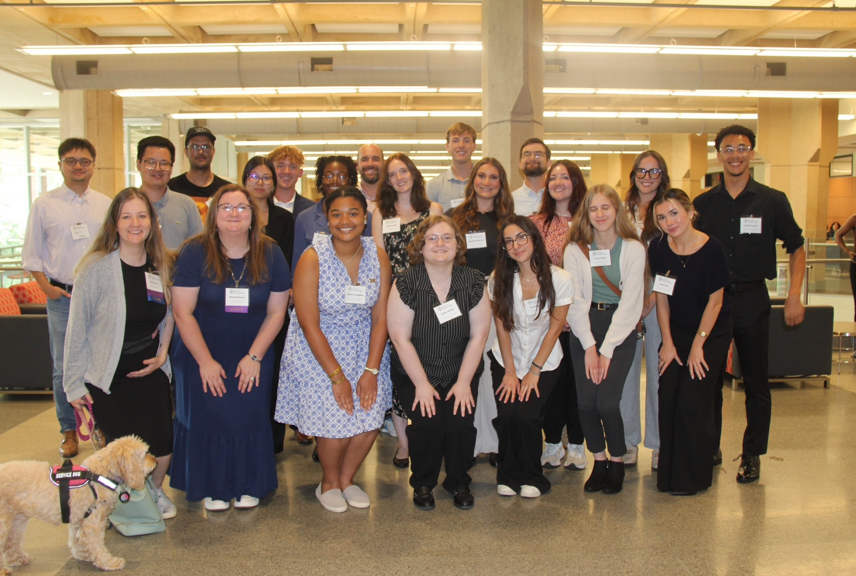 Group photo of 2025 REU students and faculty standing in the Ole Miss student union