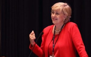 Susan Dio speaking at an industry conference