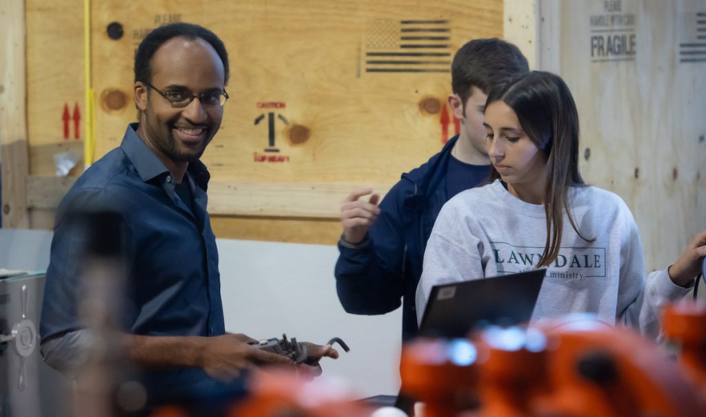 Damian Stoddard in research lab with students